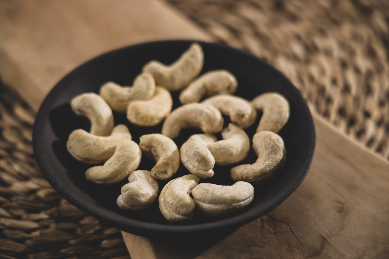 Close-Up Shot of Cashew Nuts on Black Bowl